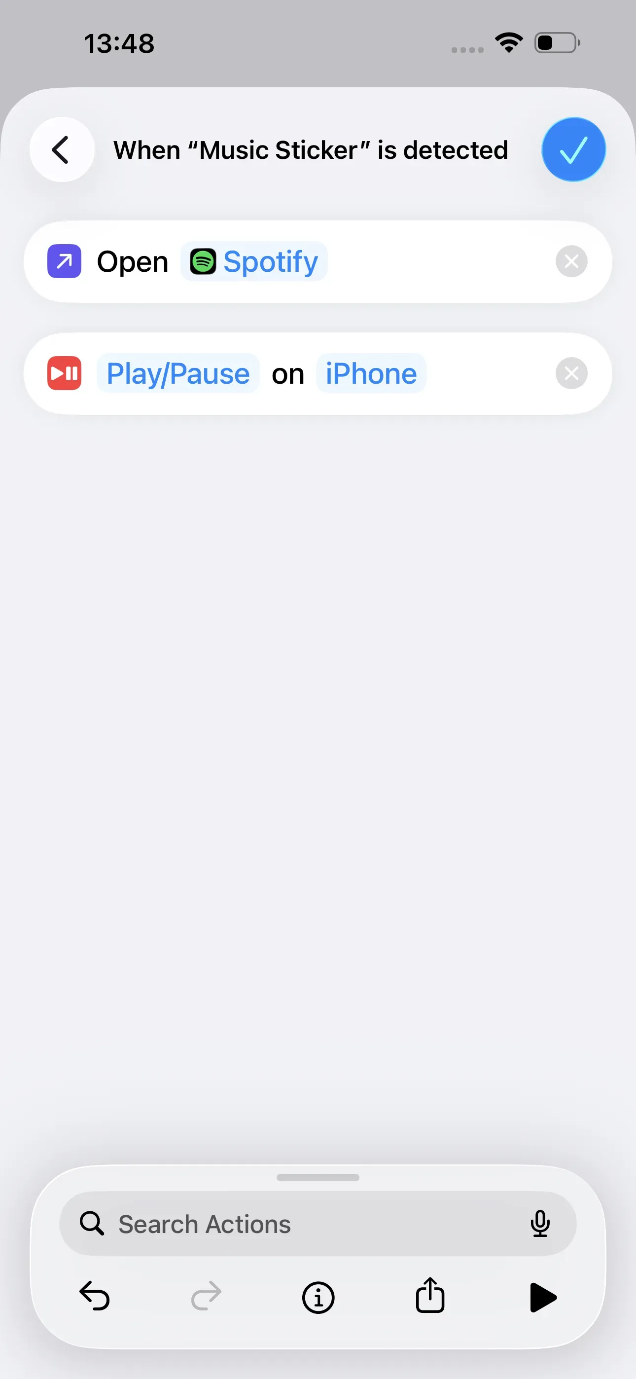 The “Open Spotify” and “Play/Pause on iPhone” actions have been selected.