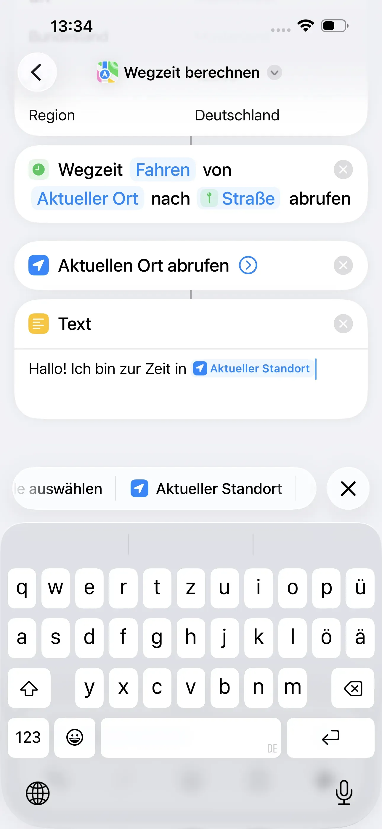 In das Textfeld wird folgendes eingegeben: „Hallo! Ich bin zur Zeit in Aktueller Standort““. Die Aktion „Aktueller Standort“ befindet sich oberhalb der Tastatur.